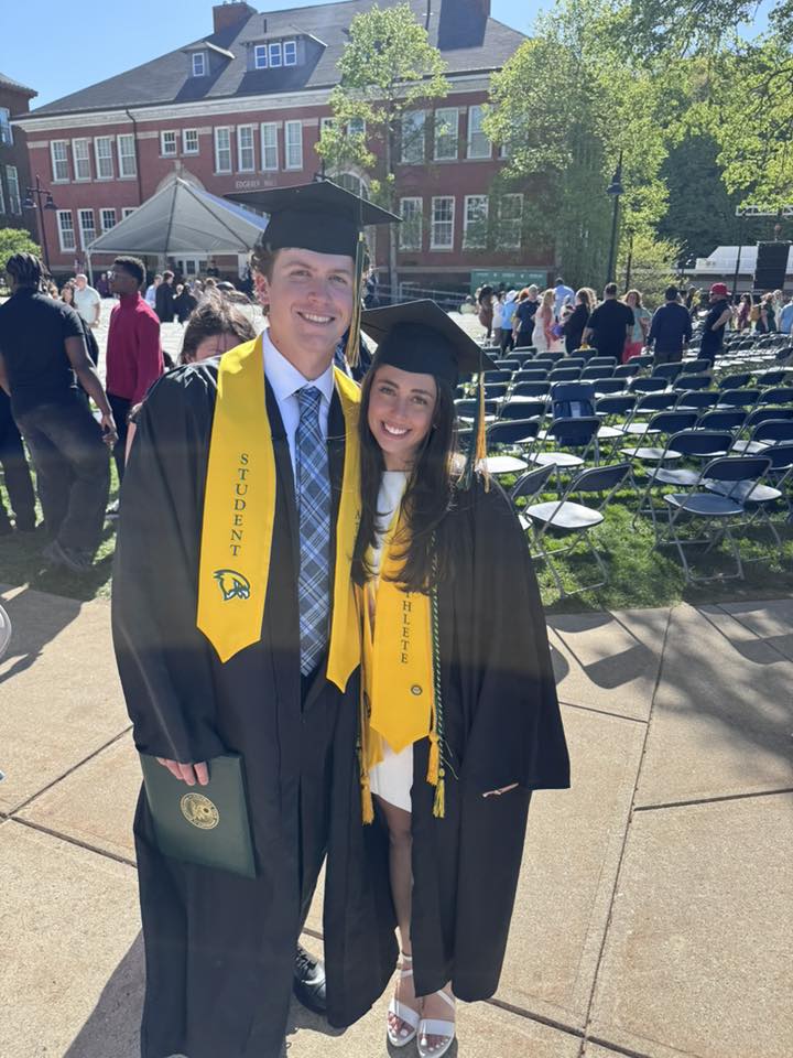 Casey Bellew at Fitchburg State commencement, in cap and gown with Student-Athlete sash